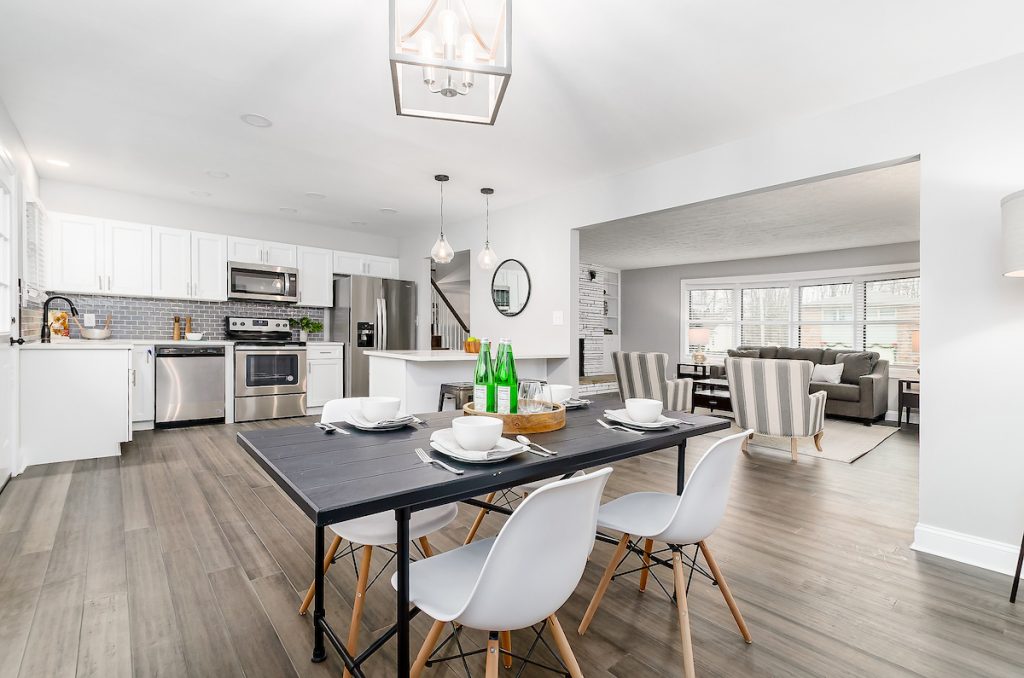 A kitchen with stainless steel appliances and a kitchen table.