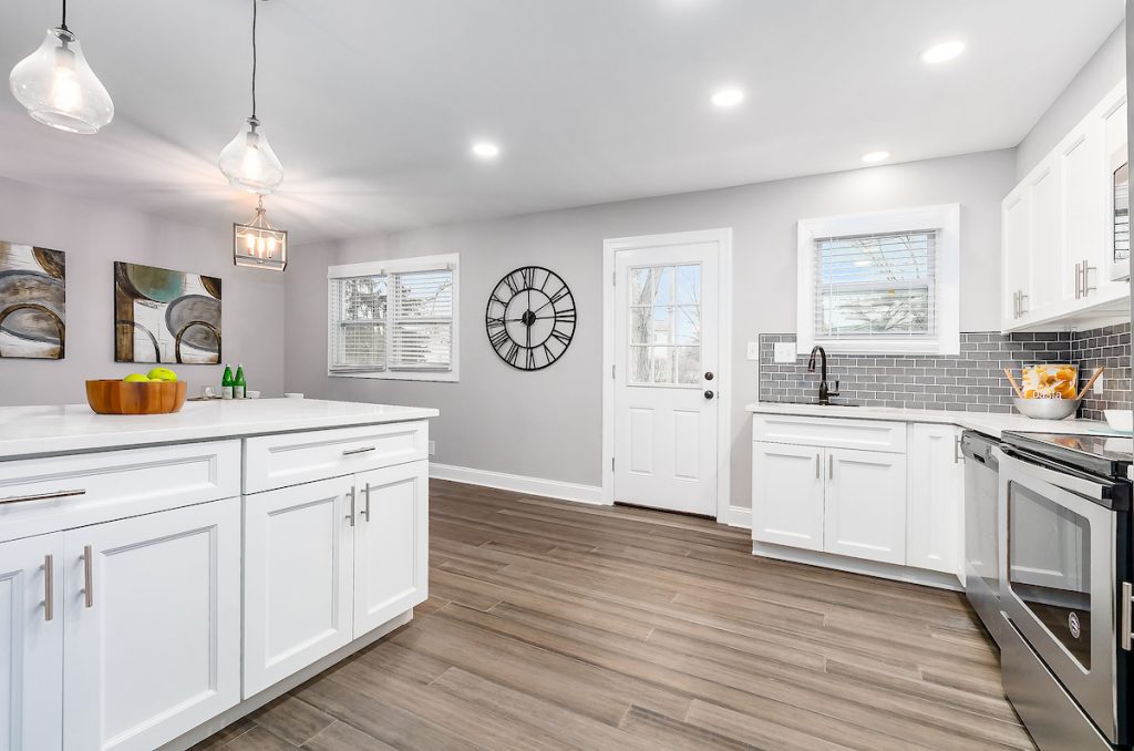 A kitchen with all white cabinets.