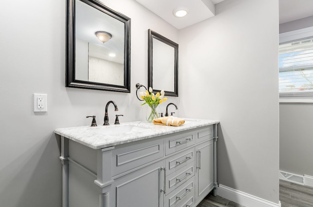 A double vanity sink with two mirrors above each sink.