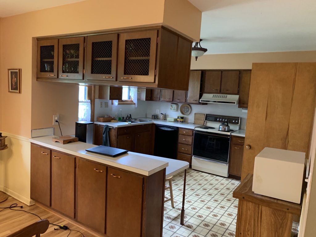 A kitchen with linoleum floors.