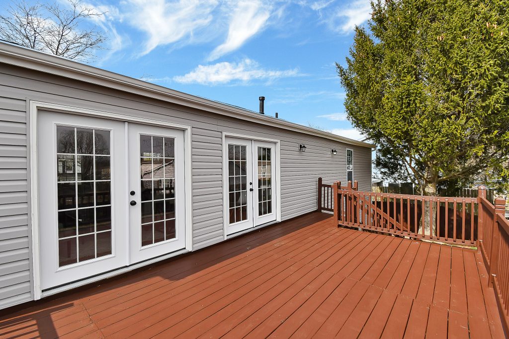 A deck on the rear exterior of a home.