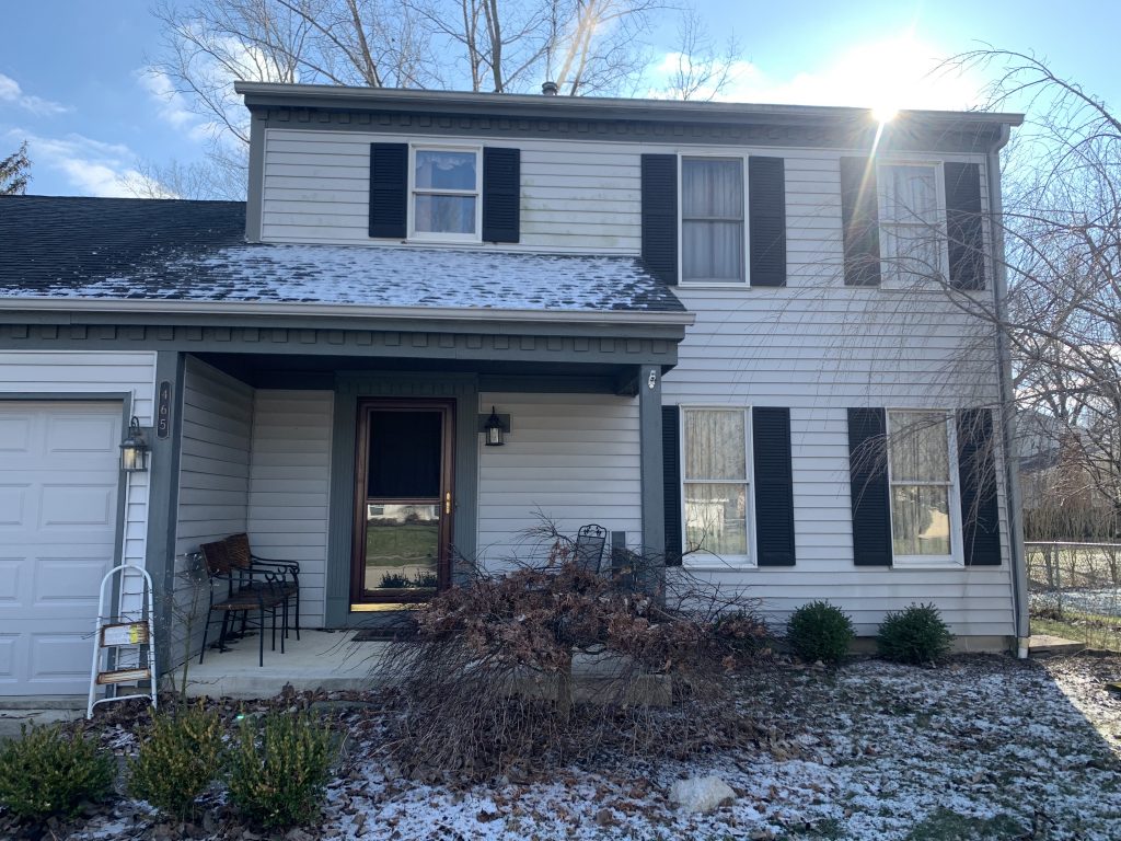 Front of home with light snow on the ground