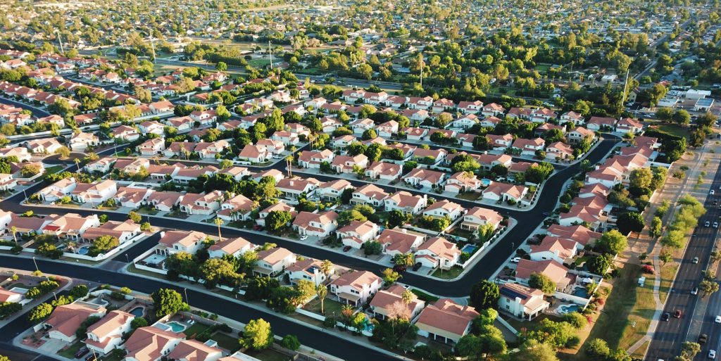 A birds-eye view of a sprawling suburban neighborhood.