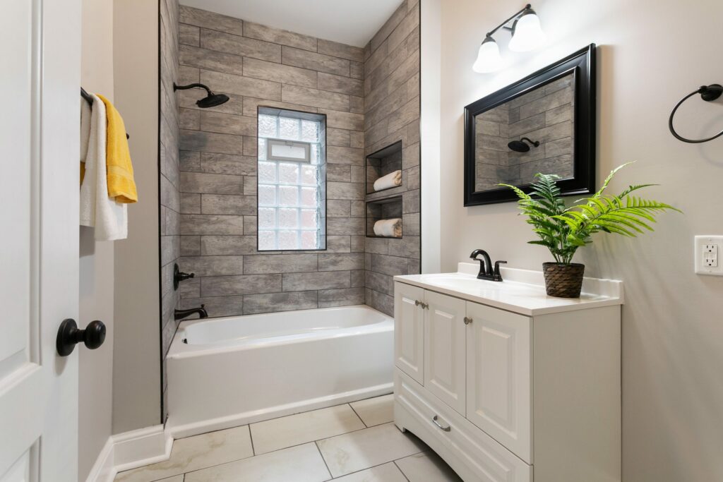 An elegant bathroom with a potted fern.