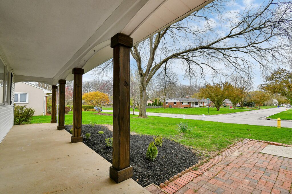 The large porch and front yard of a Columbus home.