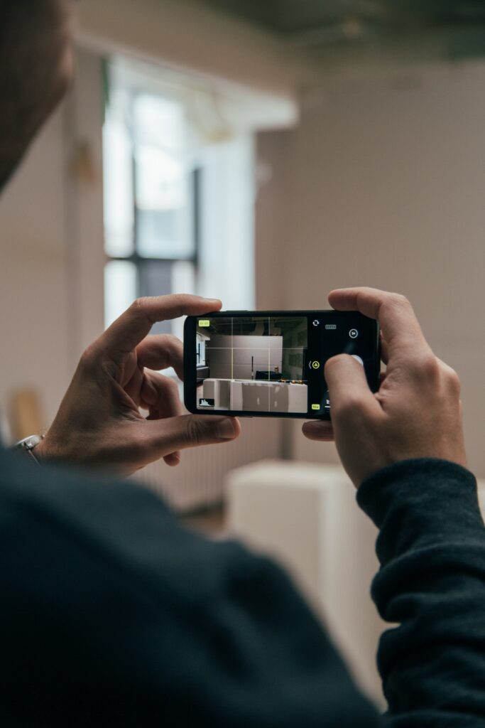 A man looking through a camera at the inside of a home.