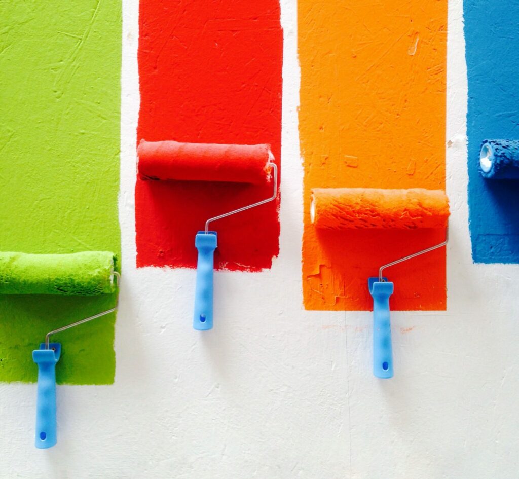 Streaks of green, red, orange, and blue from paint rollers.