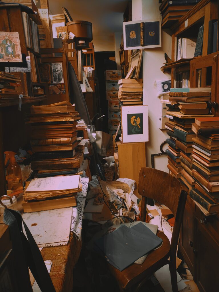 A room still full of books and junk prior to decluttering the home.