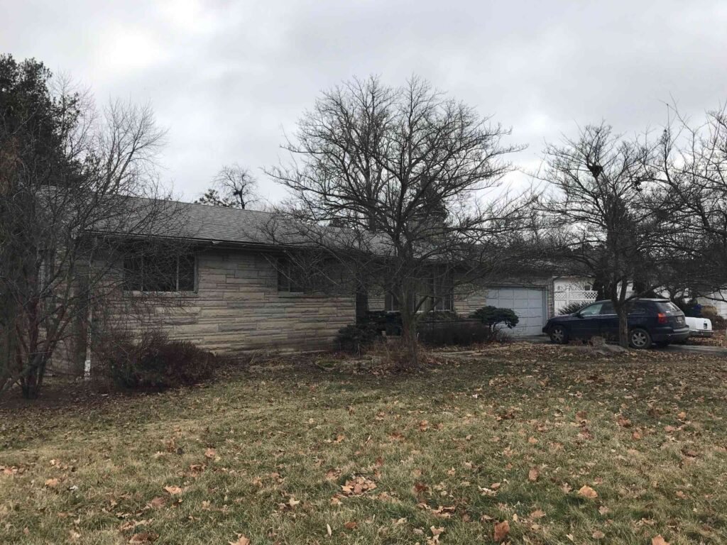 The front of an ugly house in need of renovation work.