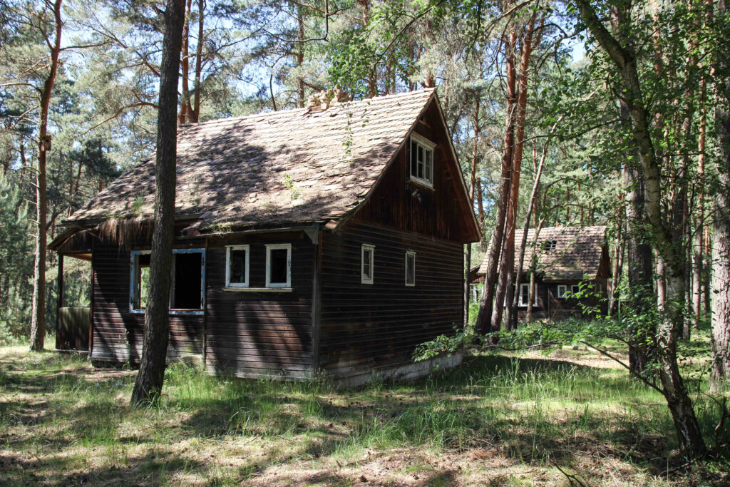 Two ugly houses in the woods.