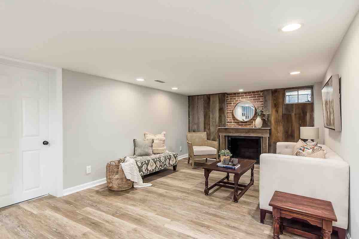 A basement living room remodeled by The Upward Home Solutions house buying company.