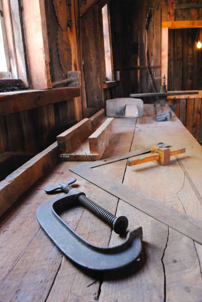 A workbench with tools on it in a garage woodshop.